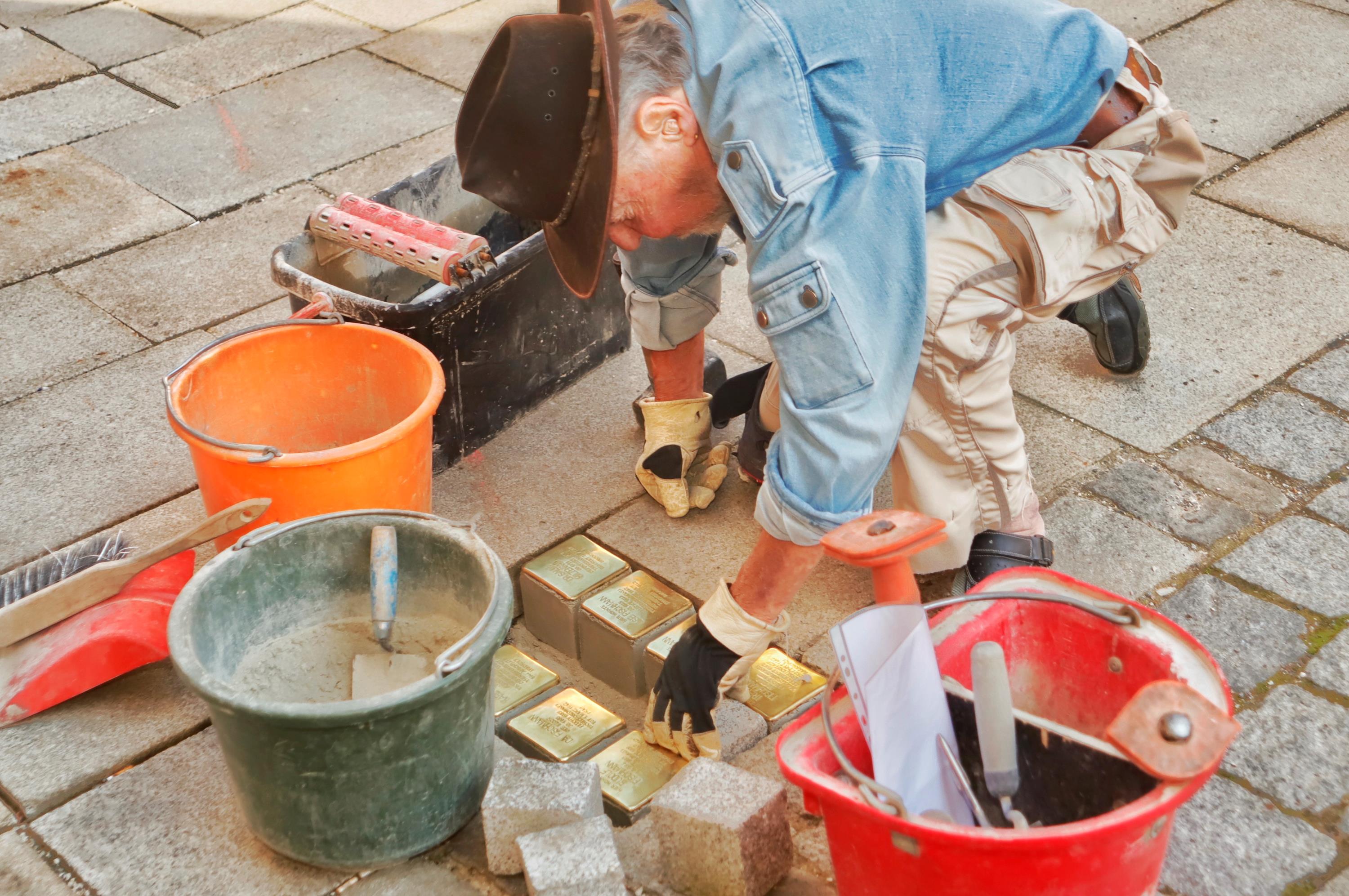 Gunter Demnig verlegt die Stolpersteine vor dem Haus Klostergasse 24, wo später Tabak Allmann zu finden war und heute ein neues Wohnhaus steht. 